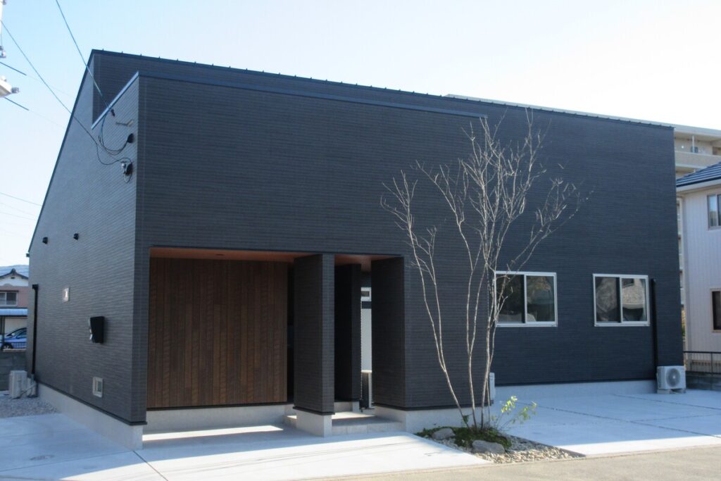 黒い外壁に木目がアクセントとなった、スタイリッシュでモダンな平屋の外観